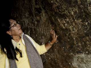 Hopi Spirit Keepers Charlene Joseph with petroglyphs at Killarumi