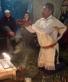 Don Xun Calixto blessing a traveler's mesa