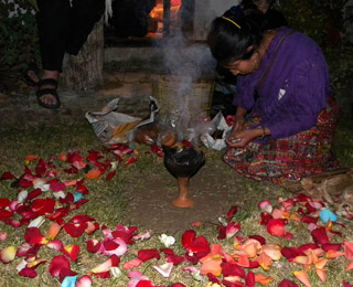 Doña Flori Pérez González preparing for the fire ceremony